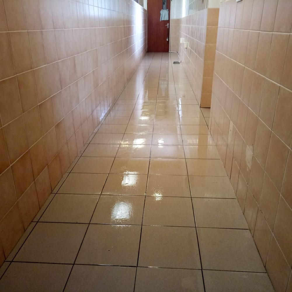 Tiled corridor after cleaning, floor clean and shining