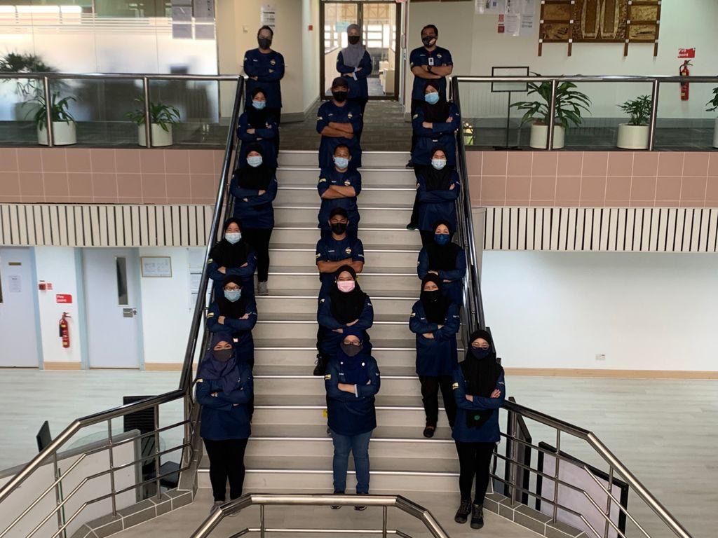 SHYT cleaning and pantry team in uniform on an office staircase