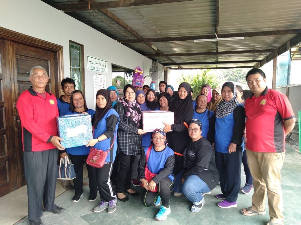SHYT staff presenting gifts and a certificate at a CSR staff appreciation event