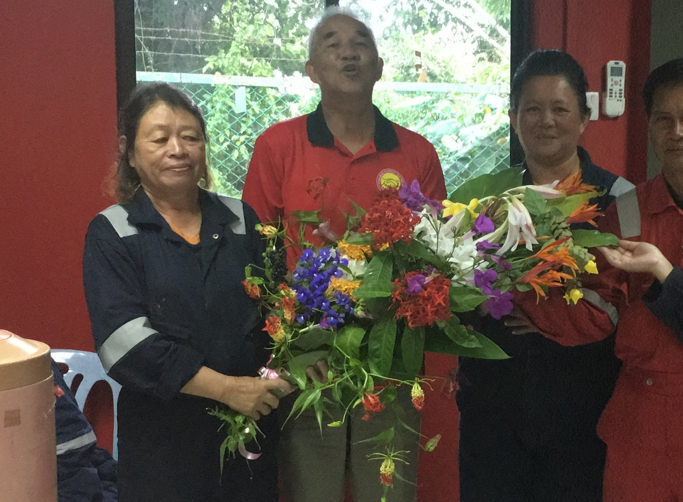 Staff presenting flowers at an appreciation day